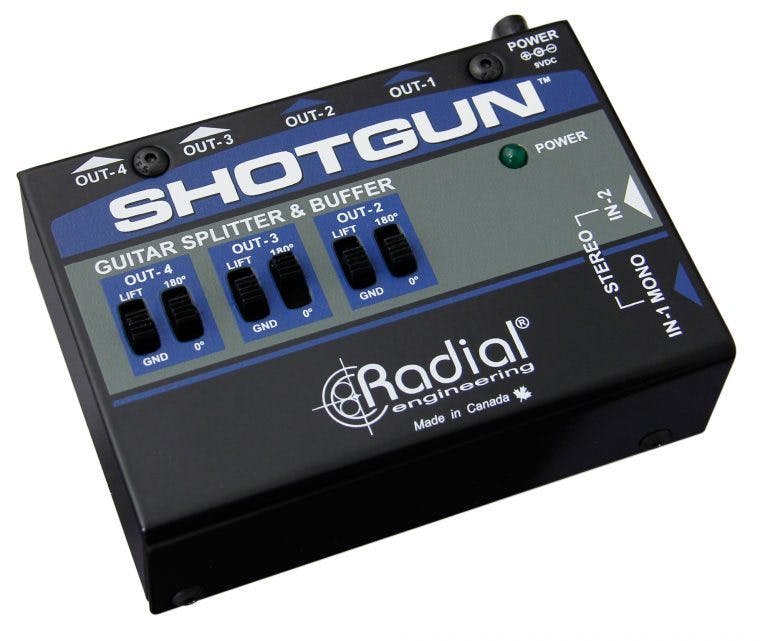 Radial Shotgun Instrument Buffer/Splitter, angled top view. Displays 1/4" mono/stereo input, four 1/4" outputs, with controls for a polarity switch and ground lift, designed to drive multiple pedals and amplifiers without signal loss.