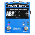 Radial Twin City Class A Active ABY Switcher, top view. Displays two latching footswitches for A/B and Y modes, LEDs for status, and controls for a buffer, ground lift, load correction and polarity reverse for high-quality signal routing to two amplifiers.