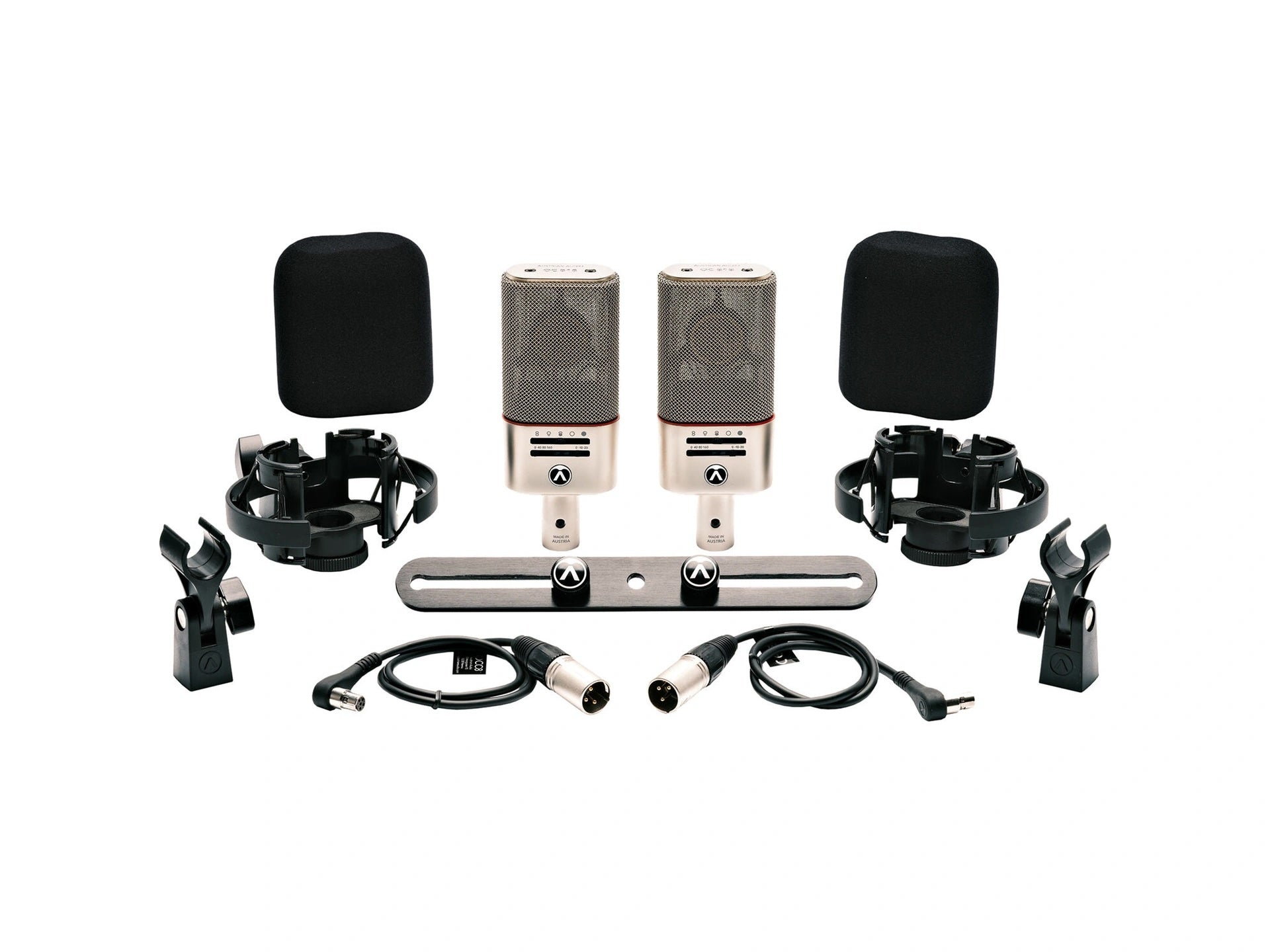 Austrian Audio OC818 Dual Set Plus Large-Diaphragm Multipattern Condenser Microphone Pair Silver contents, showcasing two OC818 microphones, shock mounts, mini-XLR cables, stereo bar, and other essential accessories neatly arranged.