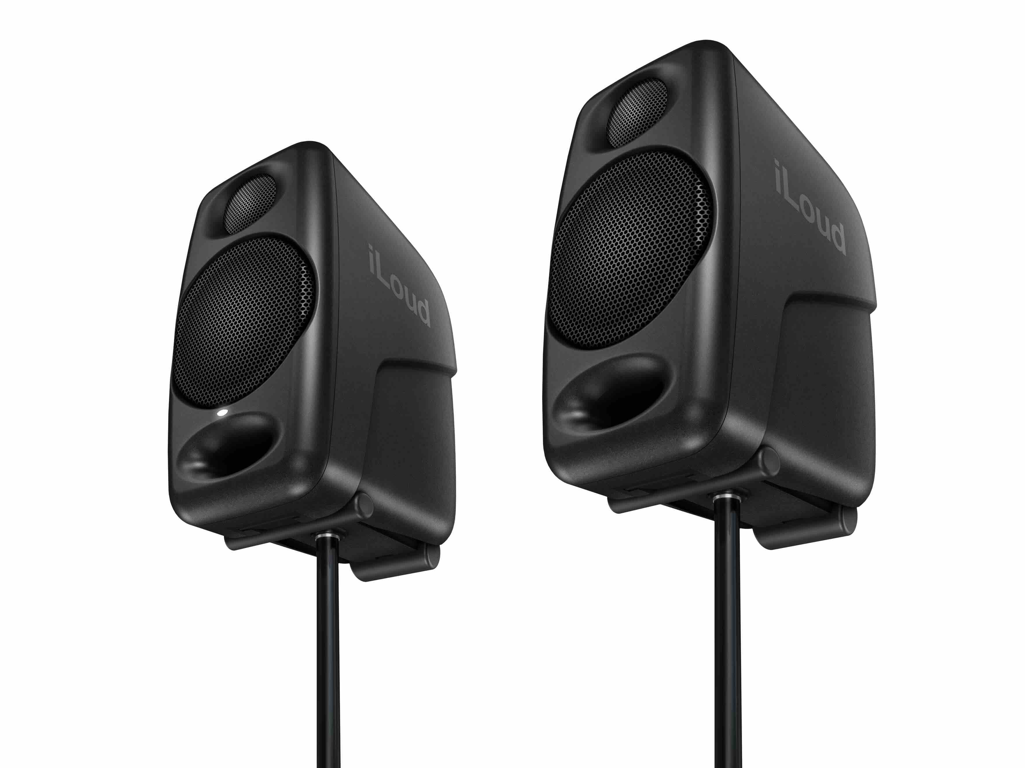 IK Multimedia iLoud Micro Monitor Pair on desktop stands, showcasing their compact size while elevated for improved acoustic performance and optimal near-field listening in portable or small studio setups.