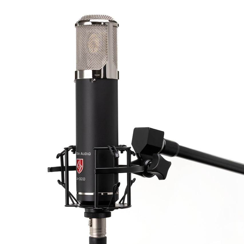 Lauten Audio LA-320 V2 Large-Diaphragm Tube Condenser Microphone side view, mounted on it custom shockmount on a mic stand, showing its grille and body, with visible switches for high-pass and low-pass filters.
