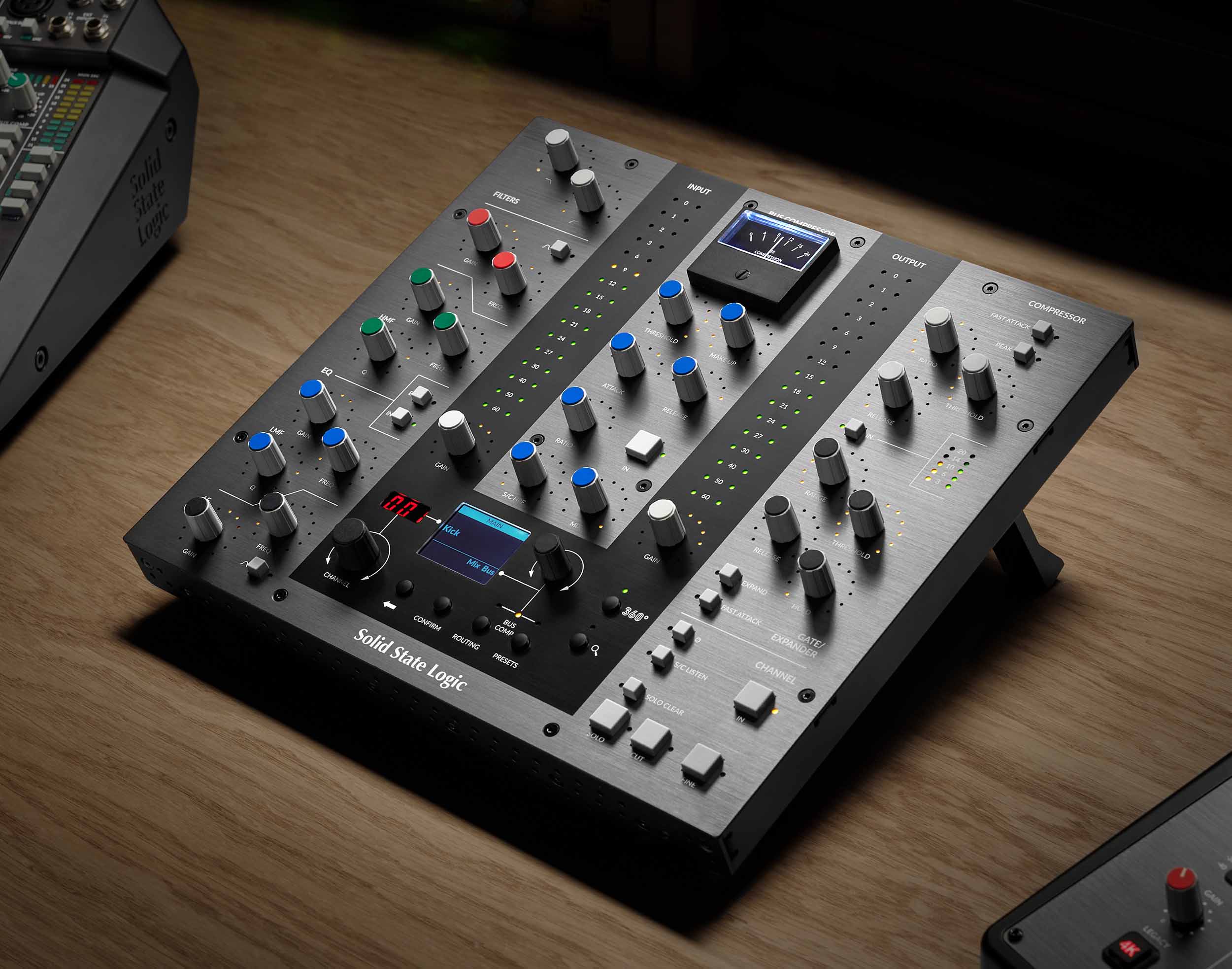 Solid State Logic UC1 Advanced Plug-in Controller angled promo, showcasing its dedicated console-style layout with a prominent central display, clearly laid out sections for SSL's Channel Strip and Bus Compressor plug-ins, including numerous rotary encoders and switches for EQ, dynamics, and a dedicated gain reduction fader.