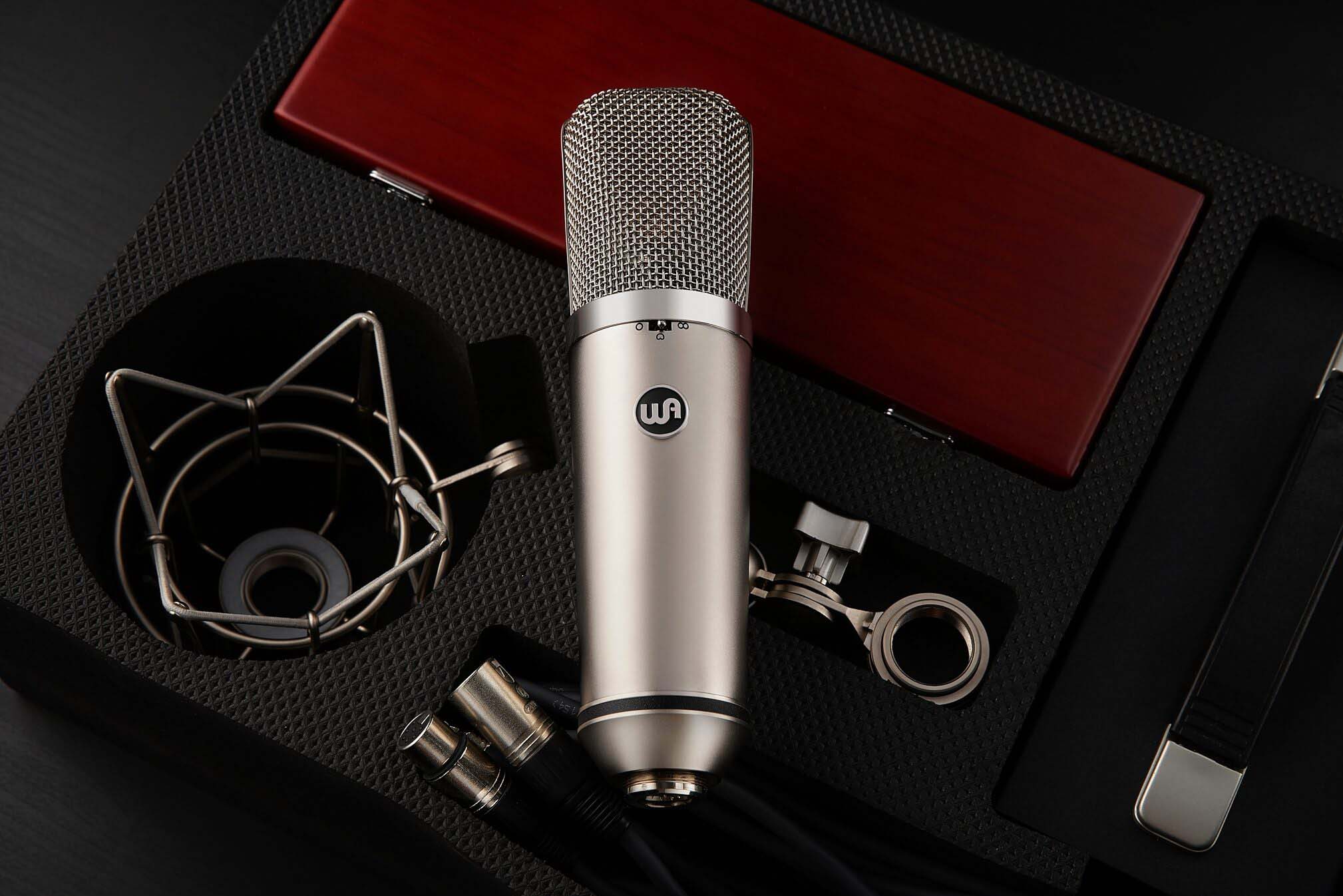 Warm Audio WA-67 Tube Large-Diaphragm Condenser Microphone ontop of open protective case, with custom wooden box, shockmount, mic cable and power supply.
